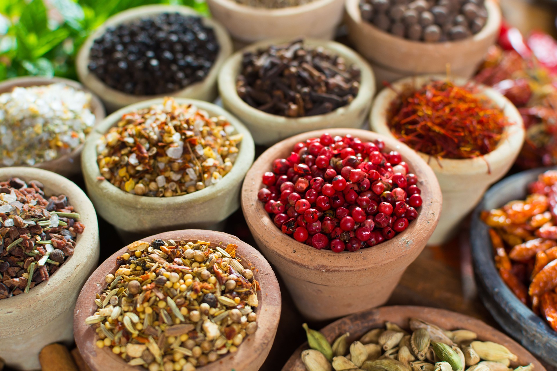 Variety of different asian and middle east spices, colorful assortment, on old wooden table